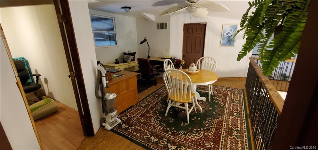 21 Lake Adger Road Mill Spring, NC 28756 - Photo 15 of 17 a dining room with furniture and a rug