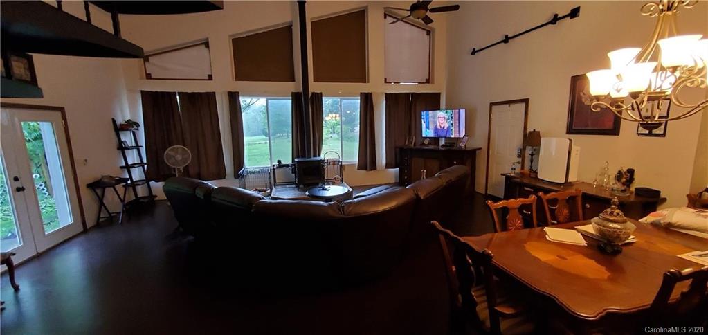 21 Lake Adger Road Mill Spring, NC 28756 - Photo 8 of 17 a view of a dining room with furniture window and wooden floor