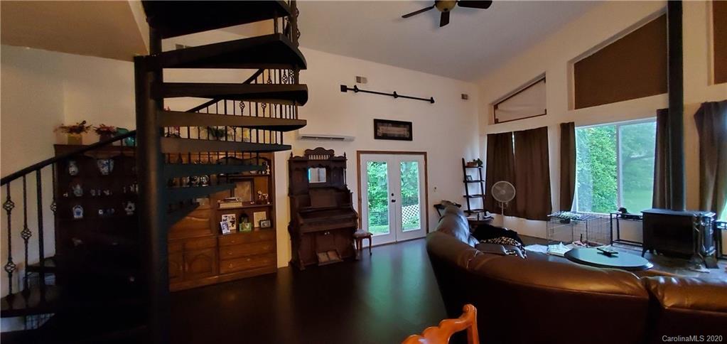 21 Lake Adger Road Mill Spring, NC 28756 - Photo 10 of 17 a living room with furniture a rug and a window