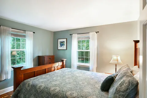a bedroom with a large bed and a window