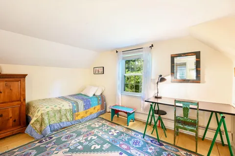 a bedroom with two beds and a window