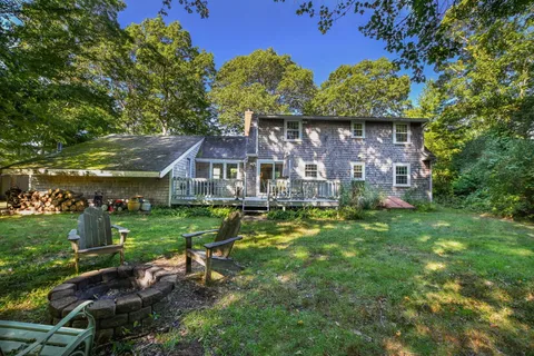 an aerial view of a house with a big yard