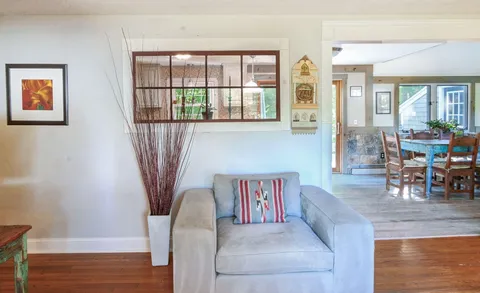 a living room with furniture and a floor to ceiling window