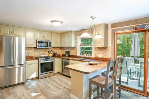 a kitchen with a stove a sink and a refrigerator