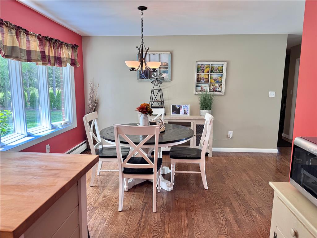 5334 Egypt Road Laurys Station, PA 18059 - Photo 10 of 55 Hardwood flooring extends throughout this dining space, illuminated by an elegant overhead chandelier.