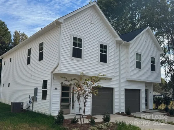 a front view of a house with garage