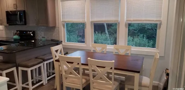 a dining room with furniture and a window