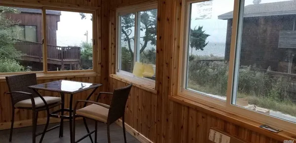a view of a balcony dining table and chairs