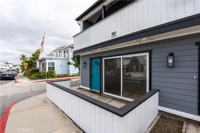 a living room with a couch and a potted plant