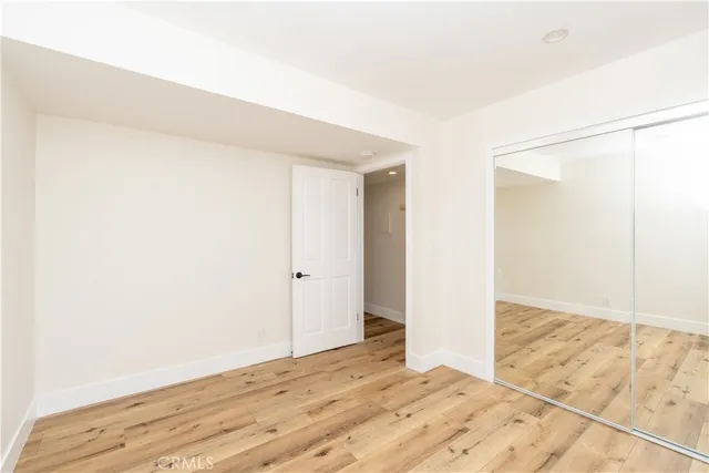 a view of a room with wooden floor and white walls