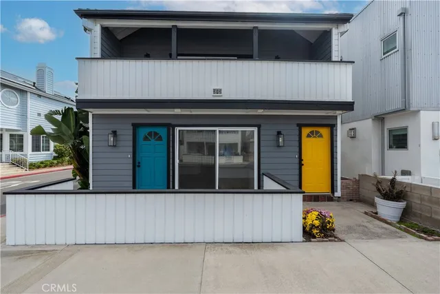 a white house that has a street sign on it