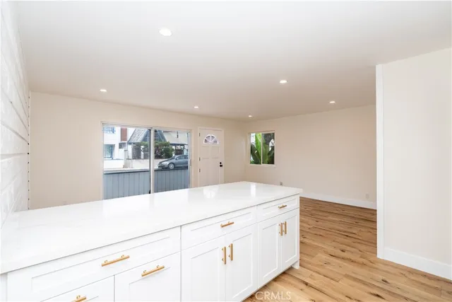 a kitchen with cabinets stainless steel appliances and a sink