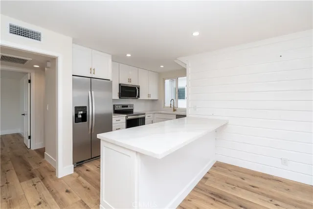 a view of kitchen with wooden floor