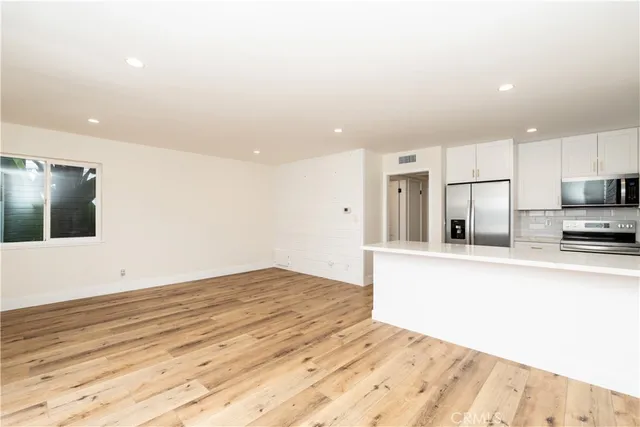 a view of a kitchen with wooden floor