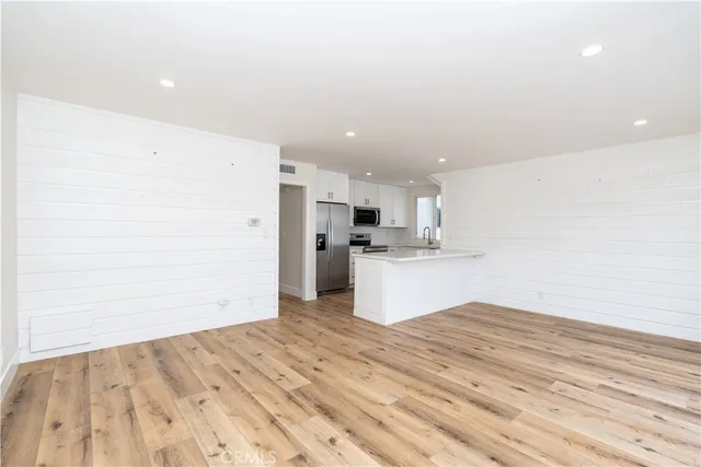 a view of a kitchen with wooden floor