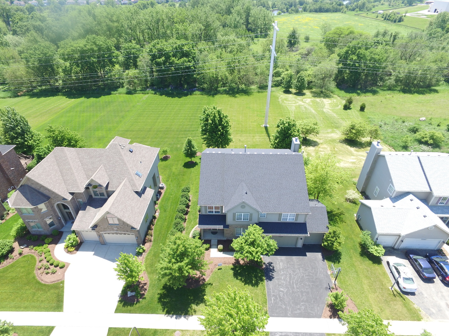 an aerial view of a house with garden space and outdoor seating