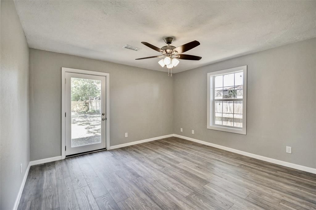 7906 Hammerly Boulevard Houston, TX 77055 - Photo 11 of 22 a view of an empty room with a window and wooden floor