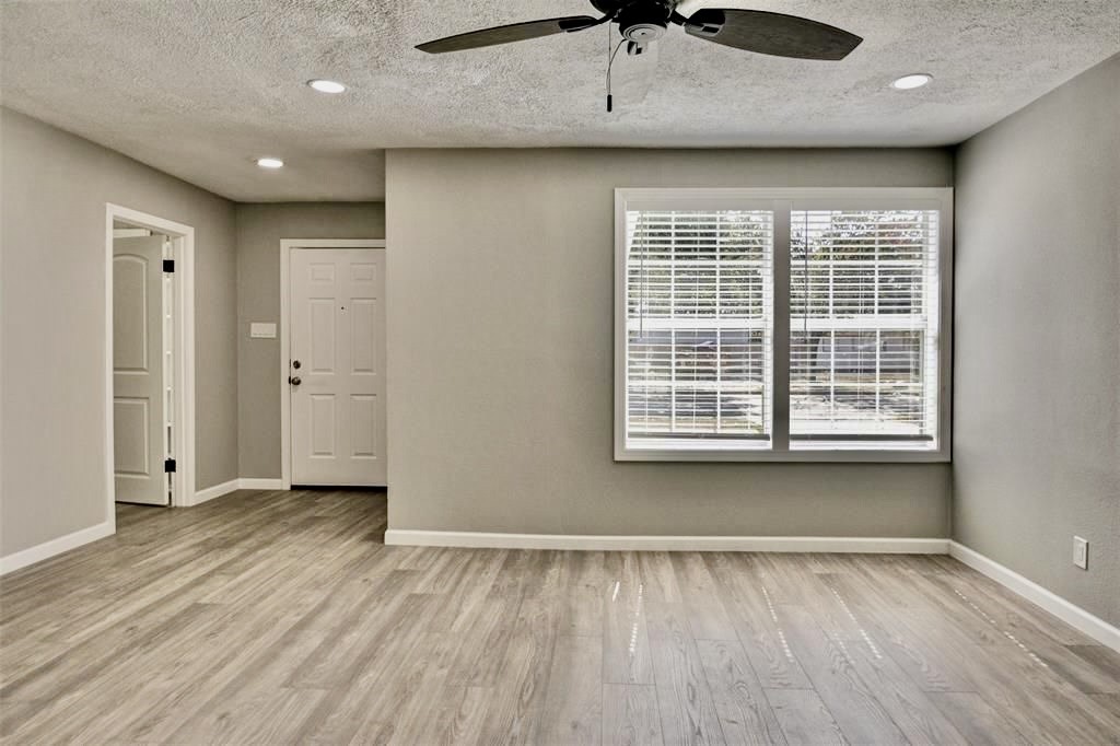 7906 Hammerly Boulevard Houston, TX 77055 - Photo 14 of 22 a view of an empty room with a window and wooden floor