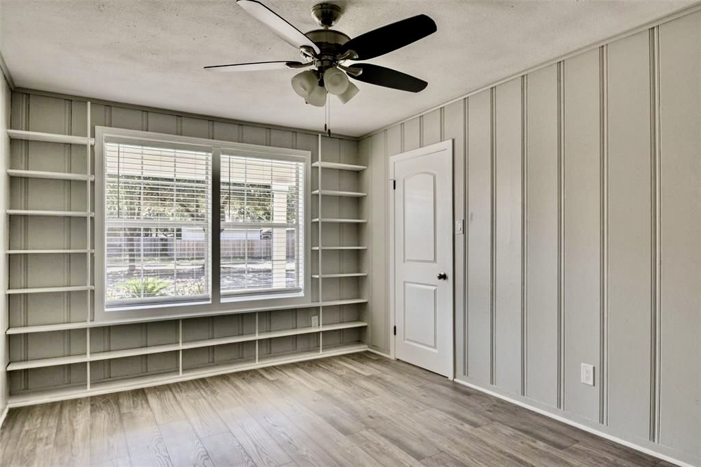7906 Hammerly Boulevard Houston, TX 77055 - Photo 16 of 22 a view of an empty room with a window and wooden floor