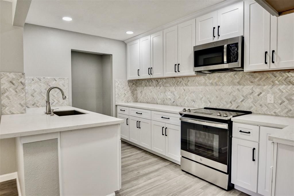 7906 Hammerly Boulevard Houston, TX 77055 - Photo 6 of 22 a kitchen with sink a microwave and stove