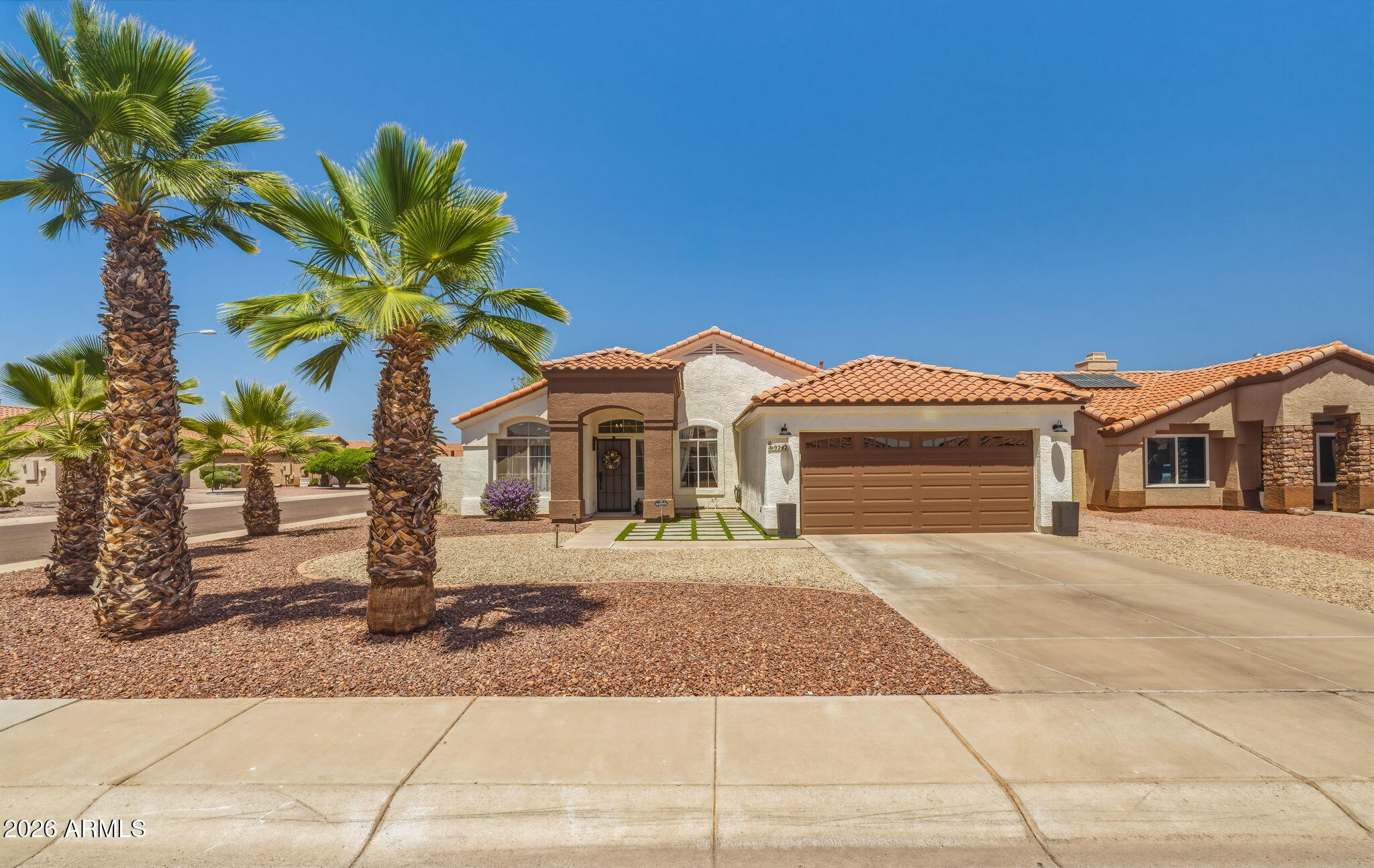 9242 West St John Road Peoria, AZ 85382 - Photo 13 of 59 a front view of a house with a yard and garage