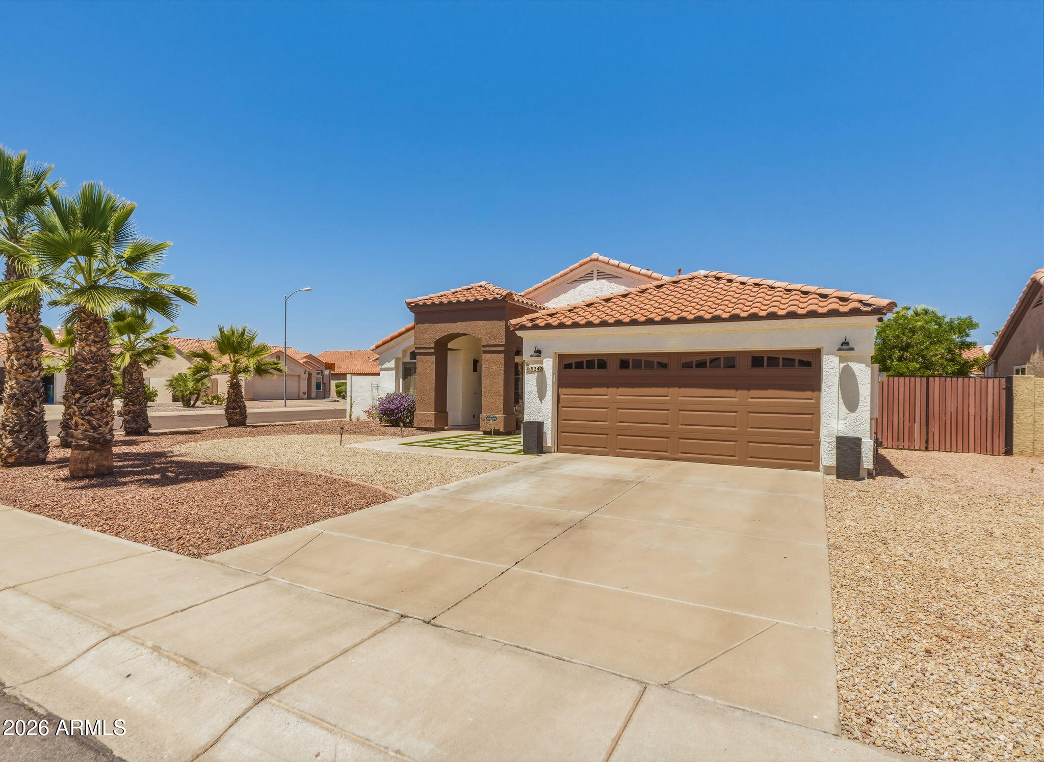 9242 West St John Road Peoria, AZ 85382 - Photo 14 of 59 a view of a house with a yard and garage