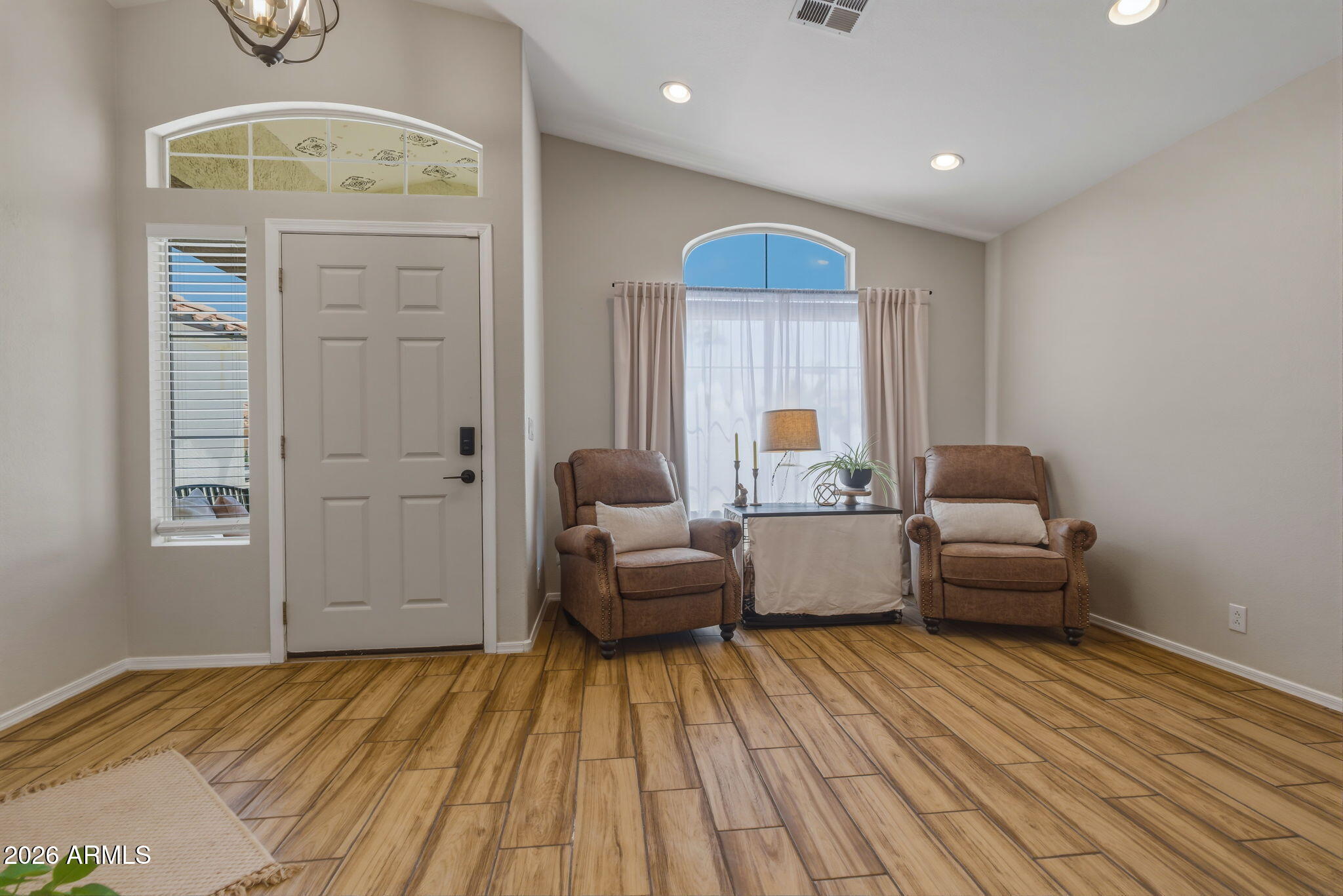 9242 West St John Road Peoria, AZ 85382 - Photo 21 of 59 a living room with furniture and a chandelier