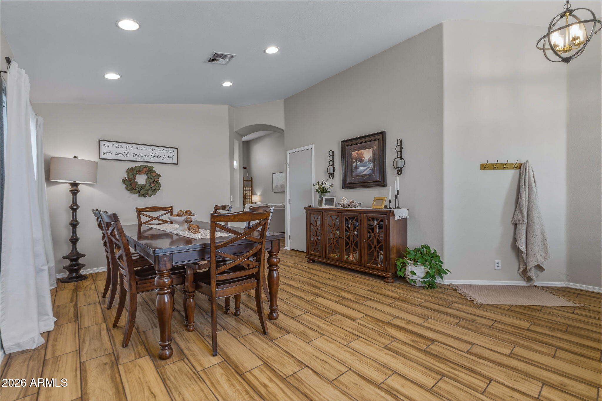 9242 West St John Road Peoria, AZ 85382 - Photo 22 of 59 a view of a dining room with furniture and wooden floor