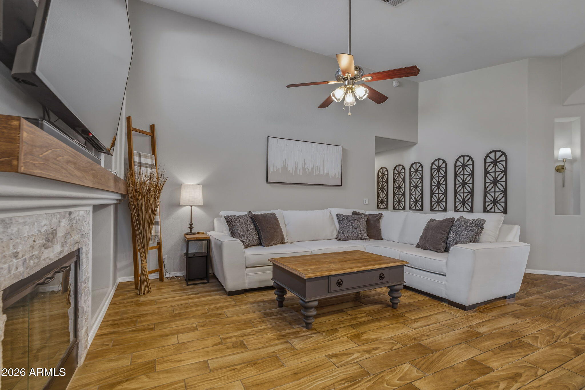 9242 West St John Road Peoria, AZ 85382 - Photo 27 of 59 a living room with furniture and a fireplace