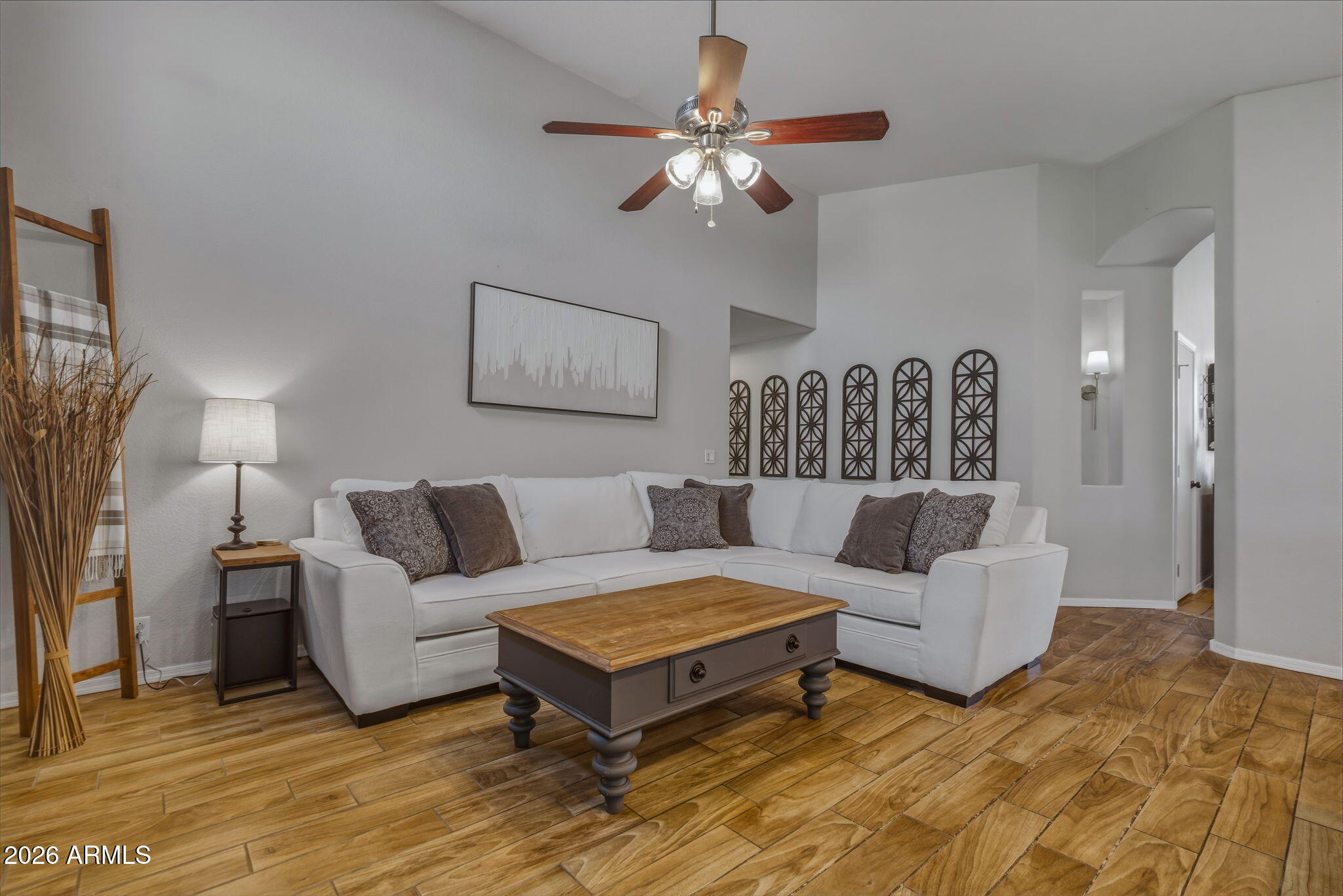9242 West St John Road Peoria, AZ 85382 - Photo 28 of 59 a living room with furniture a ceiling fan and a rug