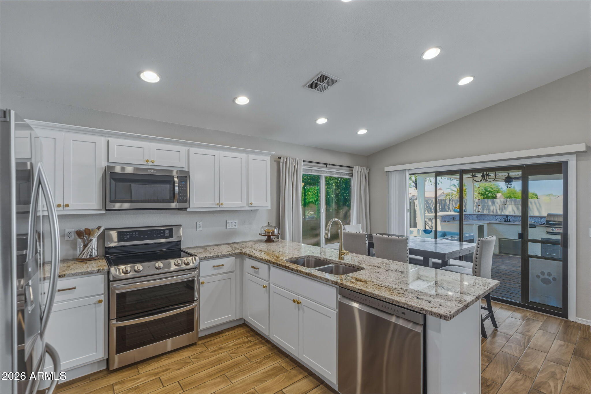 9242 West St John Road Peoria, AZ 85382 - Photo 3 of 59 a kitchen with a sink stove and microwave