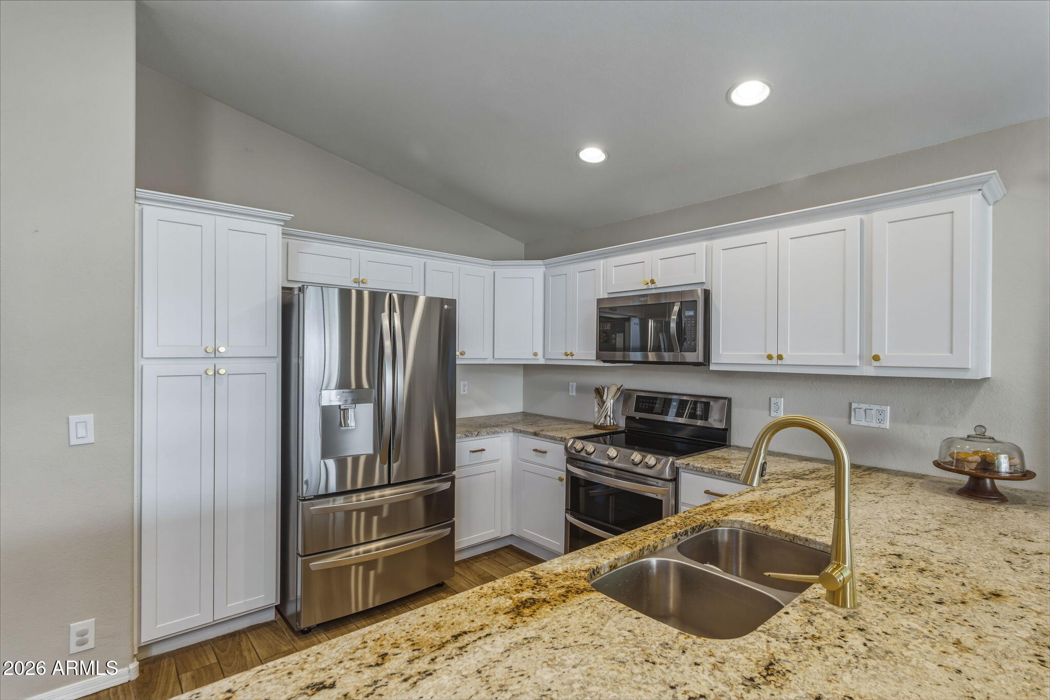 9242 West St John Road Peoria, AZ 85382 - Photo 32 of 59 a kitchen with stainless steel appliances granite countertop a refrigerator sink and stove