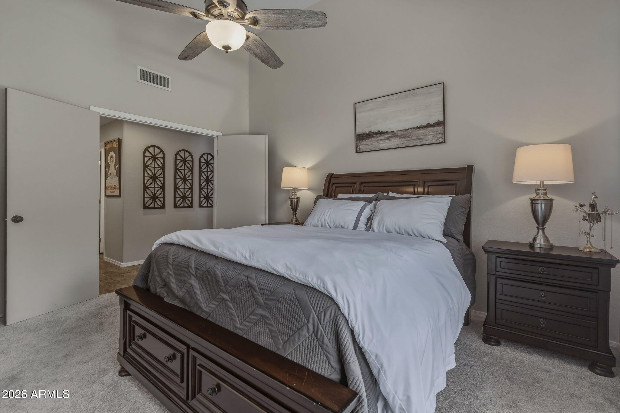 9242 West St John Road Peoria, AZ 85382 - Photo 37 of 59 a bedroom with a bed and a chandelier