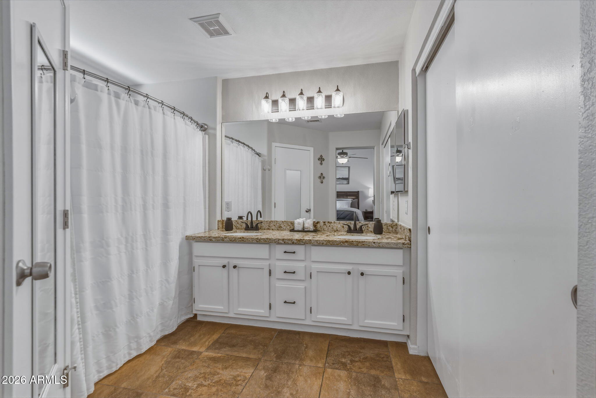 9242 West St John Road Peoria, AZ 85382 - Photo 39 of 59 a bathroom with a granite countertop sink and a mirror