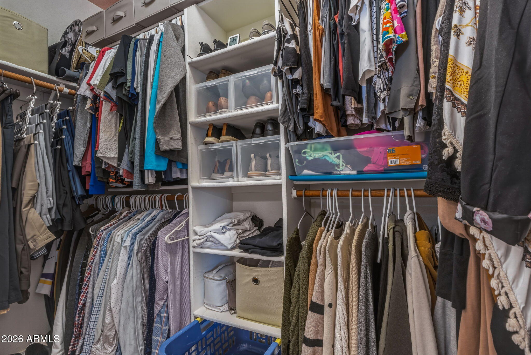 9242 West St John Road Peoria, AZ 85382 - Photo 40 of 59 a view of walk in closet with clothes and shoes