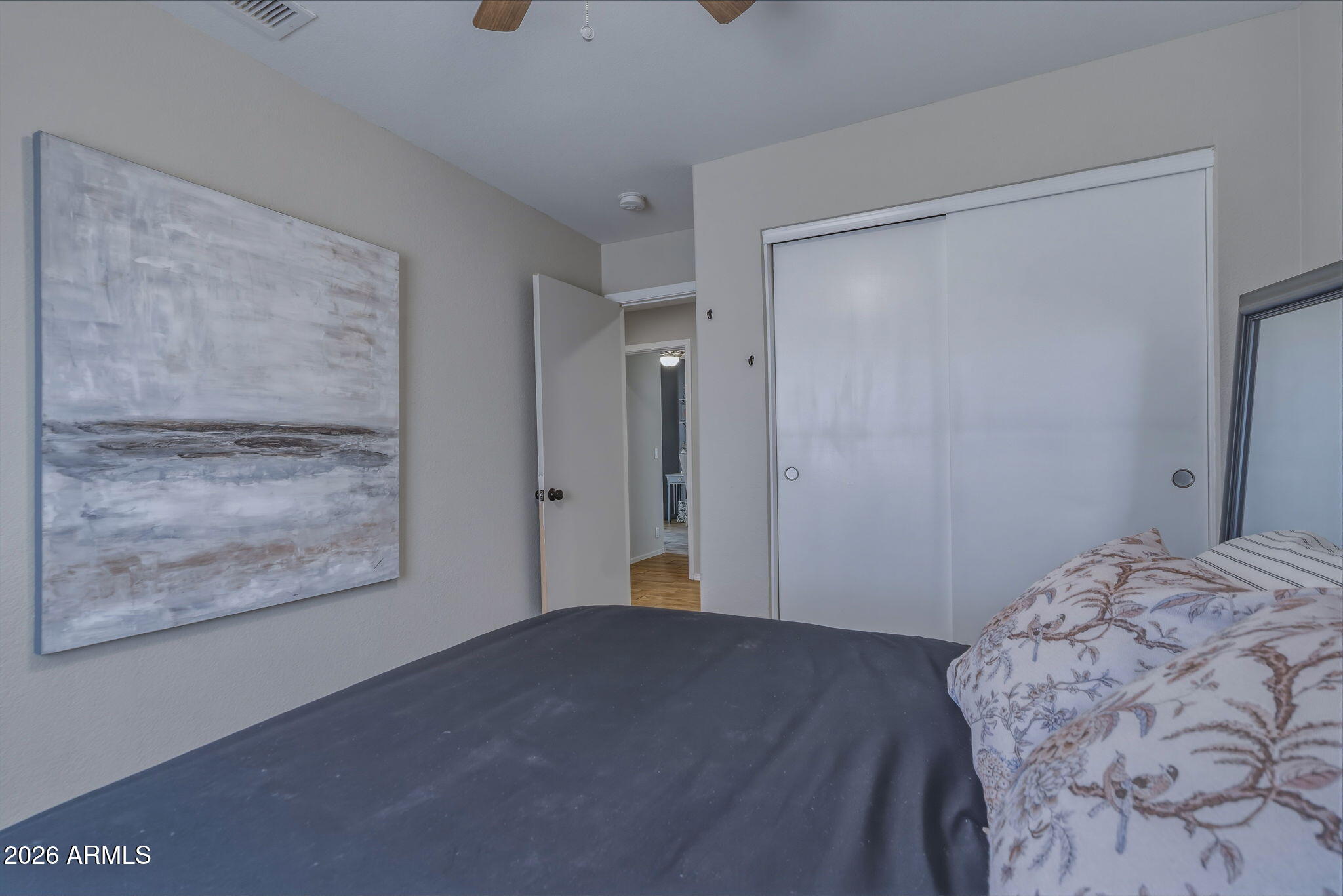 9242 West St John Road Peoria, AZ 85382 - Photo 42 of 59 a bedroom with a bed and a painting on the wall