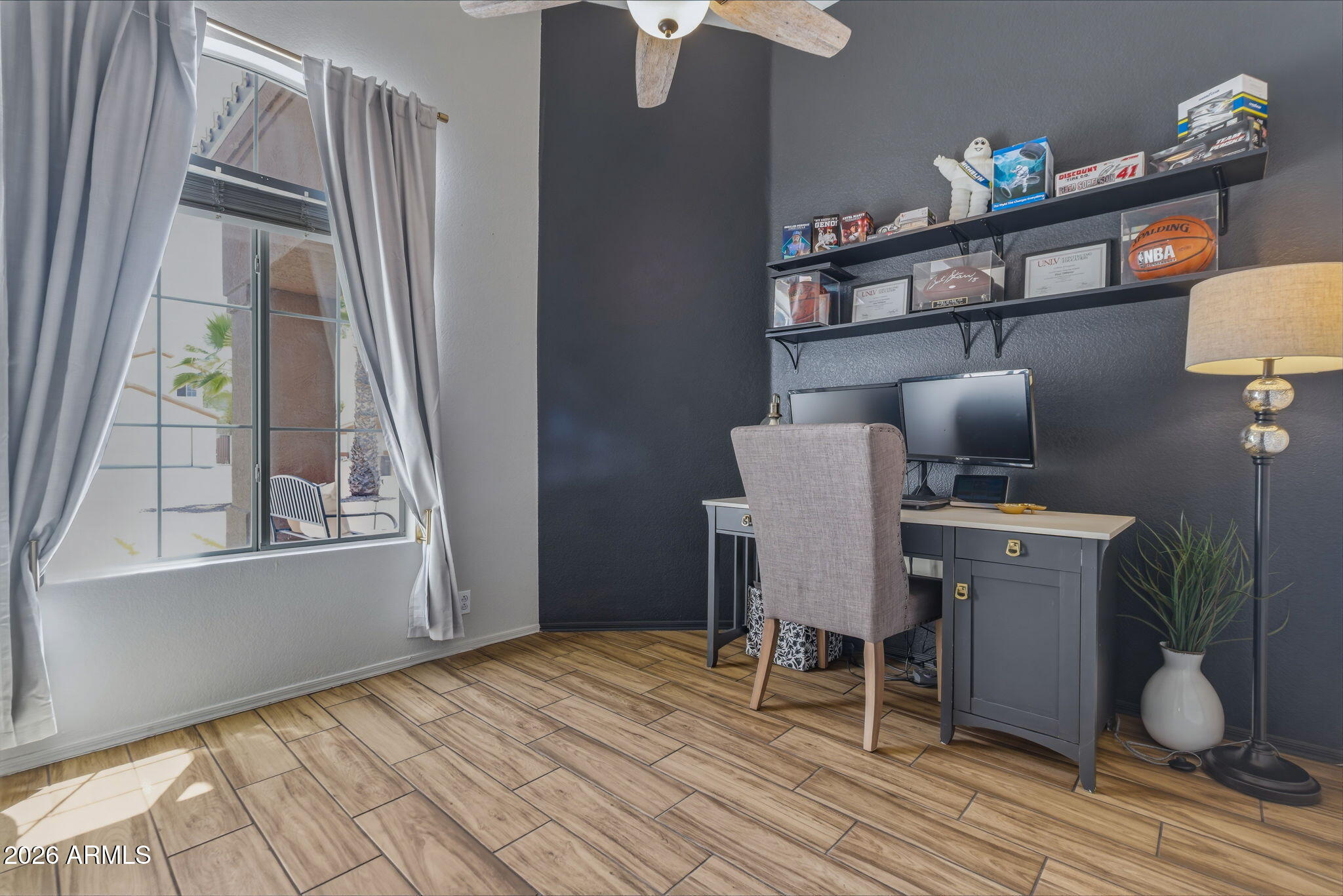 9242 West St John Road Peoria, AZ 85382 - Photo 46 of 59 a workspace with furniture window and wooden floor