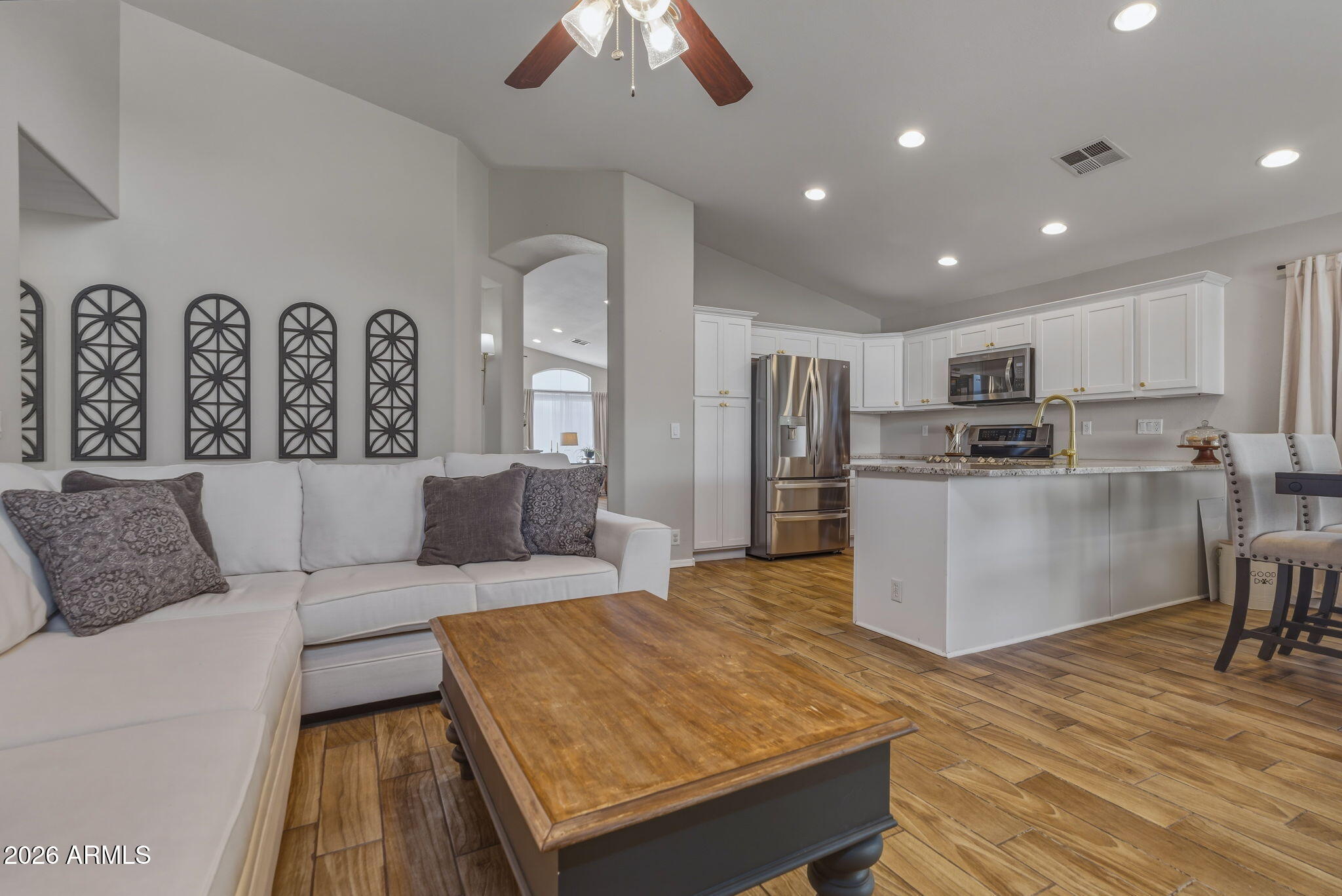 9242 West St John Road Peoria, AZ 85382 - Photo 5 of 59 a living room with stainless steel appliances kitchen island granite countertop furniture and a kitchen view
