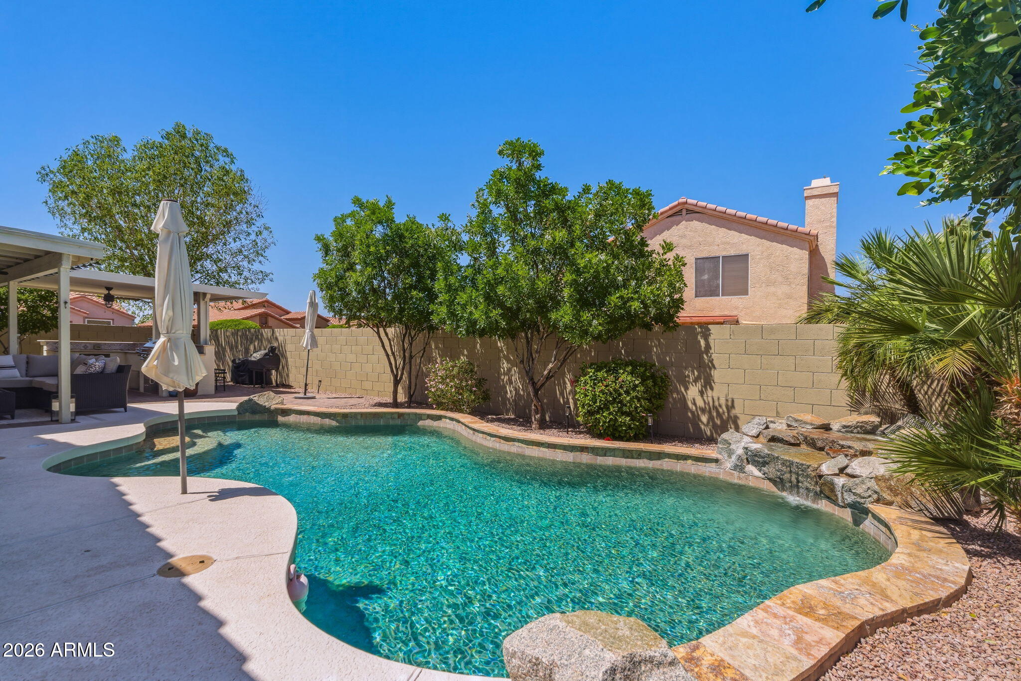 9242 West St John Road Peoria, AZ 85382 - Photo 52 of 59 a front view of a house with garden