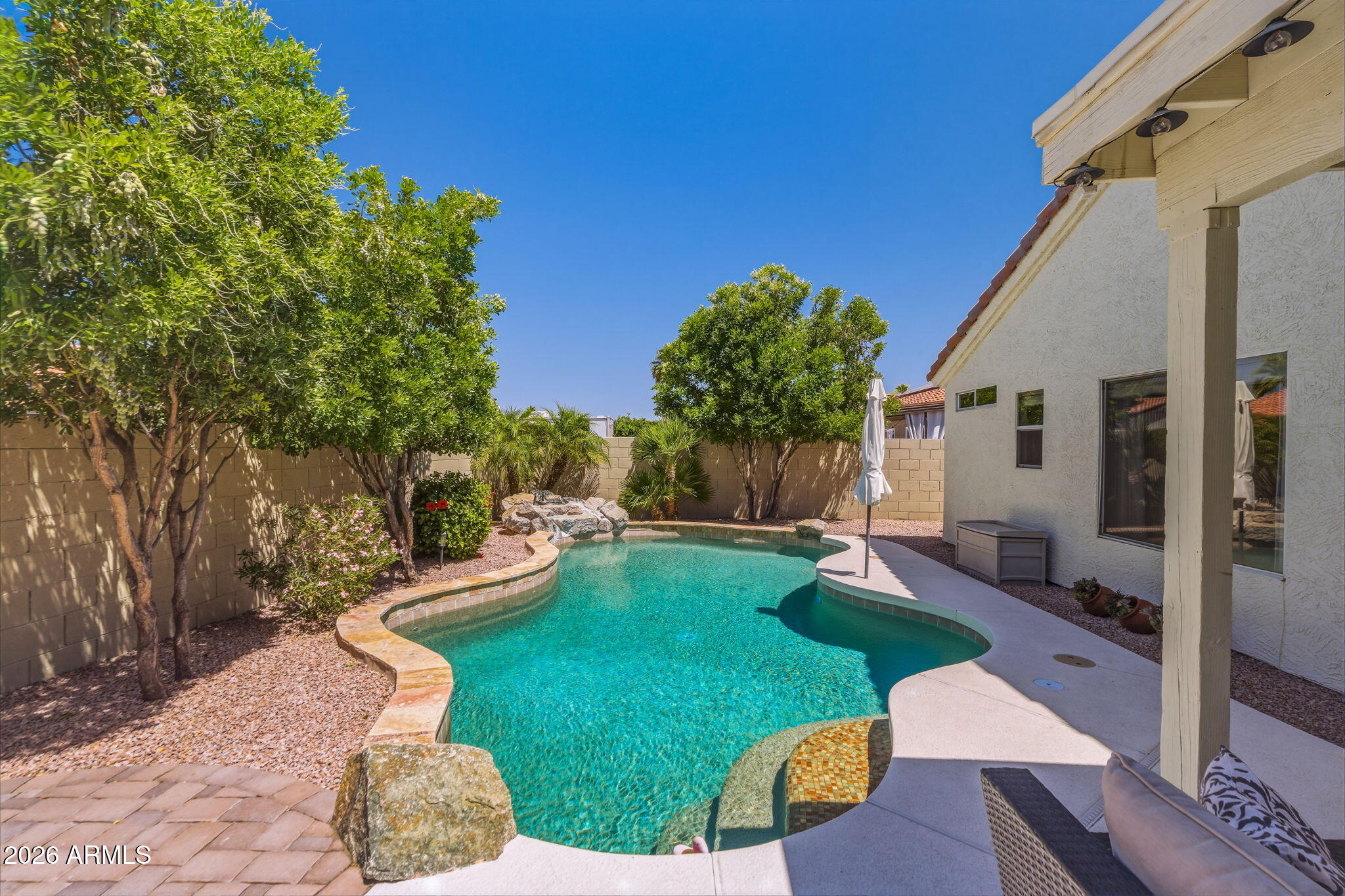 9242 West St John Road Peoria, AZ 85382 - Photo 53 of 59 a view of a backyard with couches under an umbrella