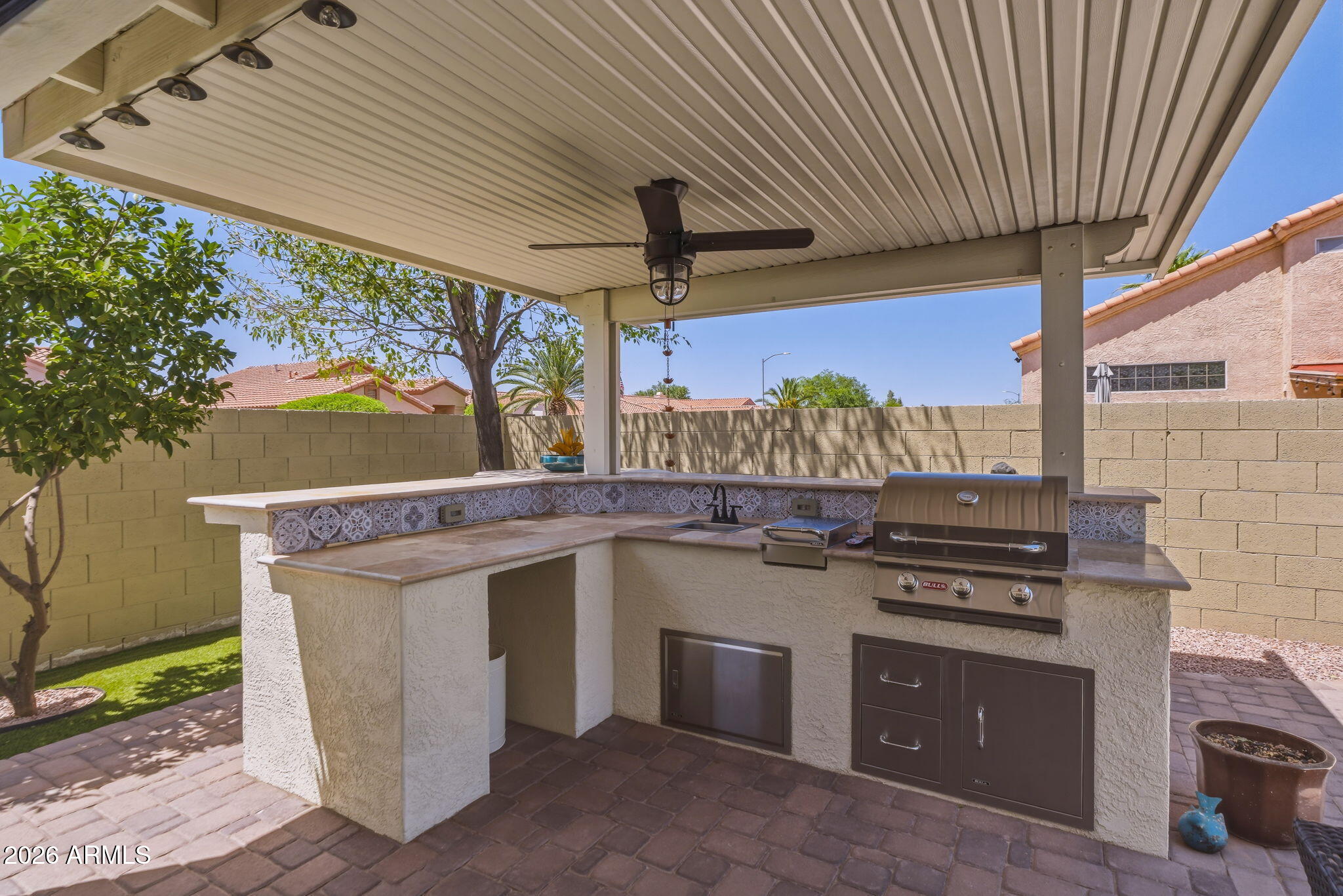 9242 West St John Road Peoria, AZ 85382 - Photo 55 of 59 a kitchen with a stove and a sink