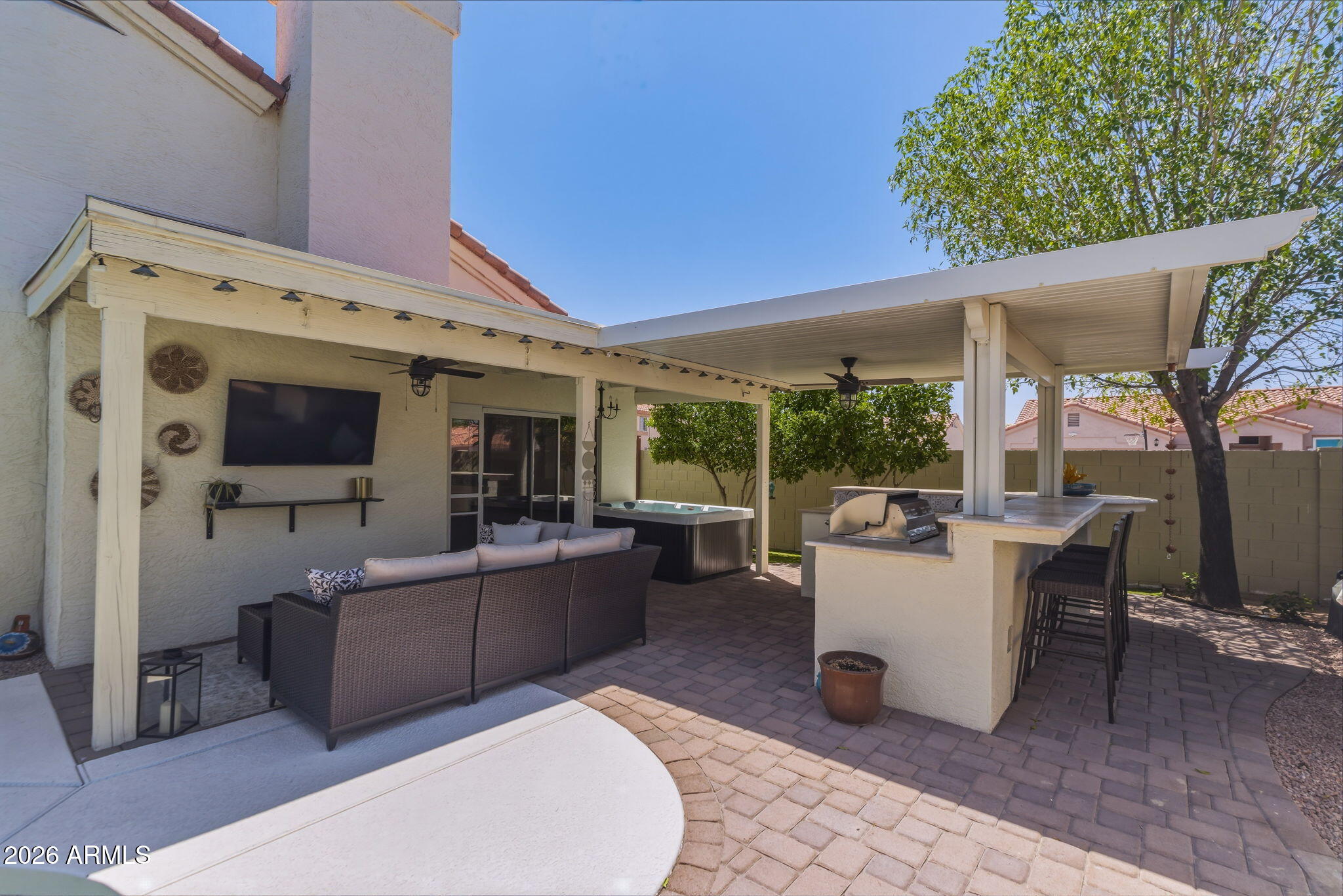 9242 West St John Road Peoria, AZ 85382 - Photo 58 of 59 a view of a patio with couches potted plants and floor to ceiling window