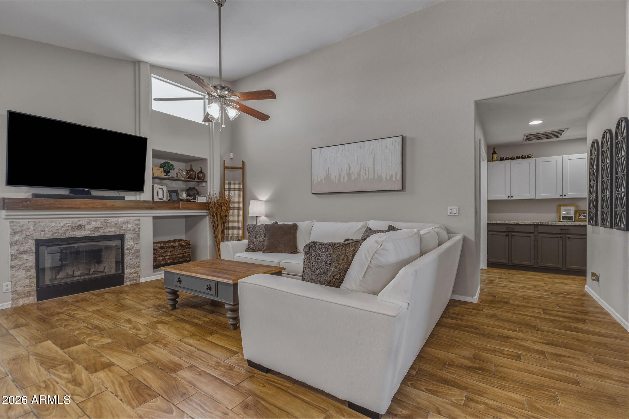 9242 West St John Road Peoria, AZ 85382 - Photo 6 of 59 a living room with furniture a fireplace and a flat screen tv
