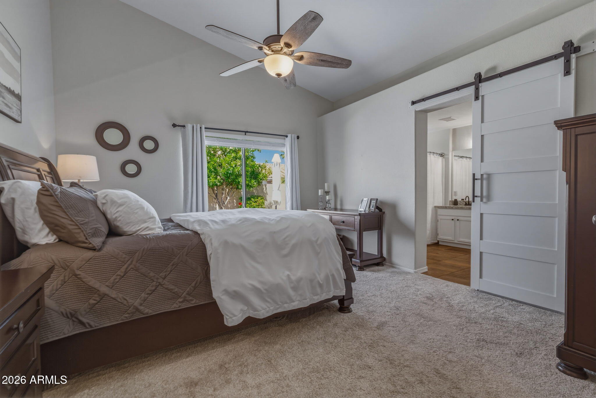 9242 West St John Road Peoria, AZ 85382 - Photo 7 of 59 a bed room with a bed and a chandelier