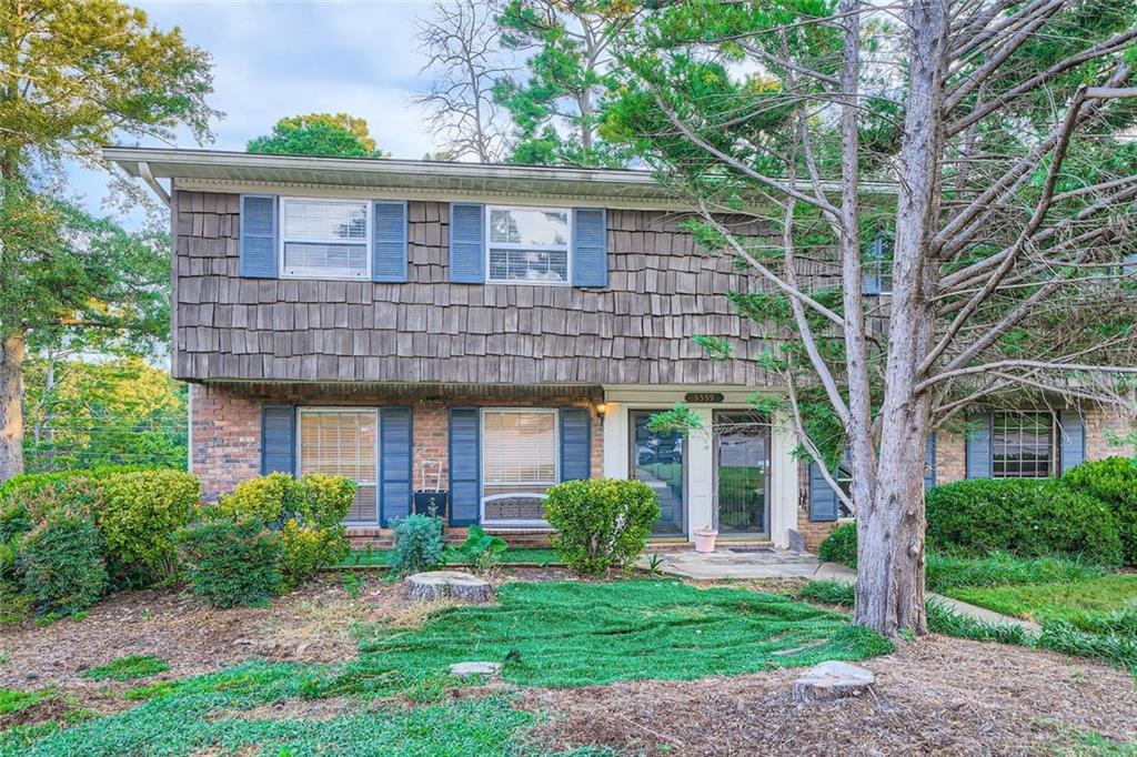 3559 Old Chamblee Tucker Road, Unit F Atlanta, GA 30340 - Photo 1 of 11 a front view of a house with a yard and potted plants