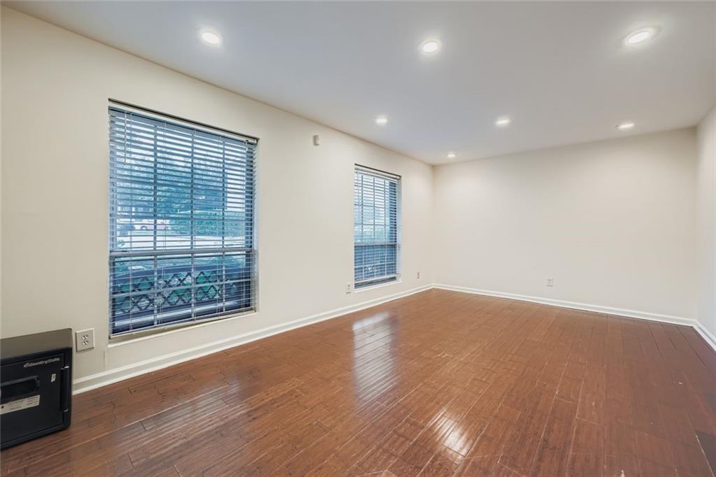 3559 Old Chamblee Tucker Road, Unit F Atlanta, GA 30340 - Photo 2 of 11 a view of an empty room with wooden floor and a window