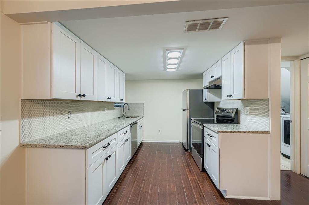 3559 Old Chamblee Tucker Road, Unit F Atlanta, GA 30340 - Photo 4 of 11 a kitchen with a sink a stove top oven and refrigerator