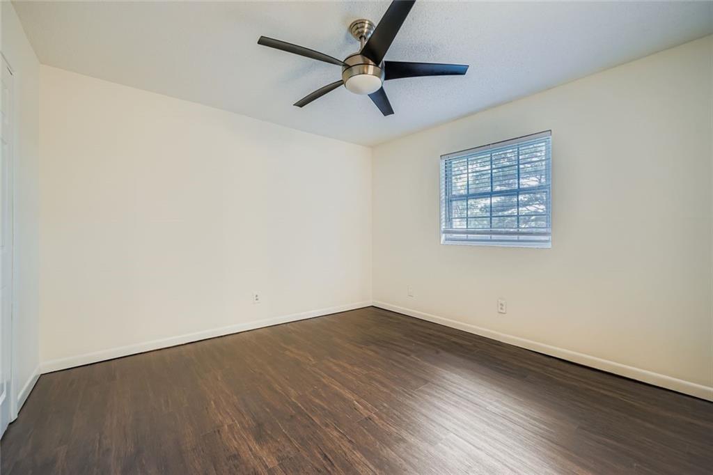 3559 Old Chamblee Tucker Road, Unit F Atlanta, GA 30340 - Photo 6 of 11 wooden floor in an empty room with a window