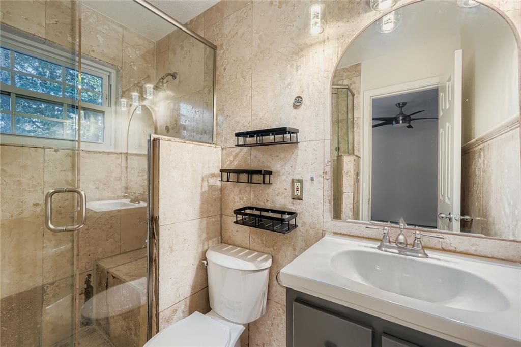 3559 Old Chamblee Tucker Road, Unit F Atlanta, GA 30340 - Photo 7 of 11 a bathroom with a sink a toilet and shower