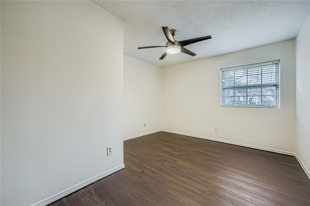 3559 Old Chamblee Tucker Road, Unit F Atlanta, GA 30340 - Photo 8 of 11 an empty room with wooden floor ceiling fan and windows
